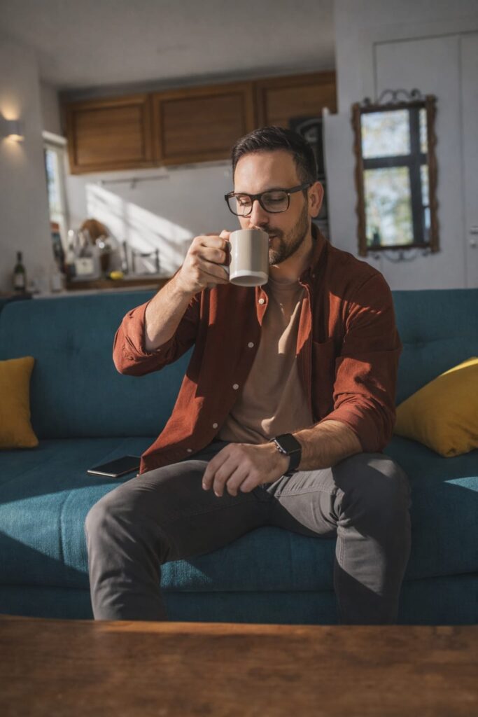 man drinking coffee at home morning routine metabolism support