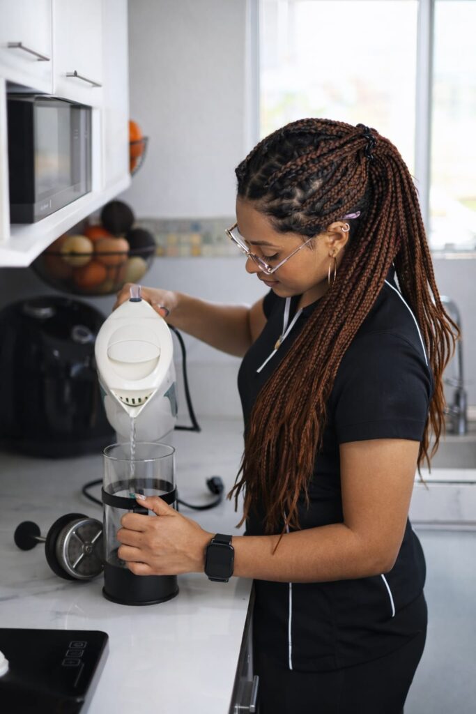 woman preparing morning coffee routine supporting metabolism and belly fat loss